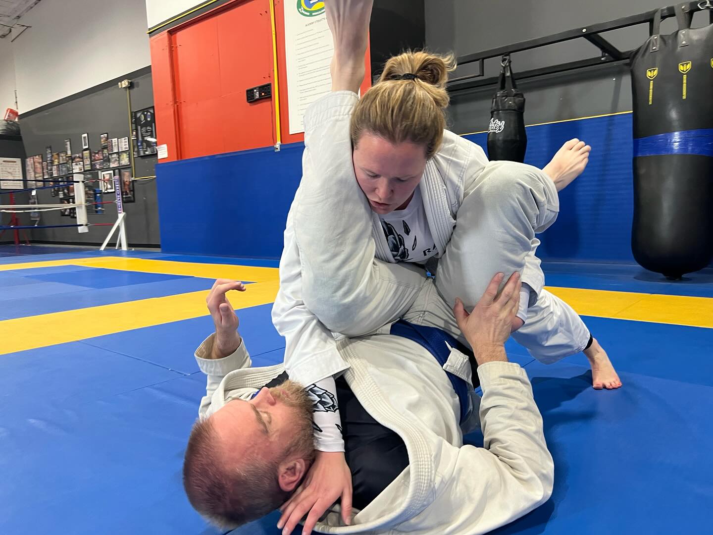 Woman passing guard in BJJ class at Zingano Broomfield Colorado