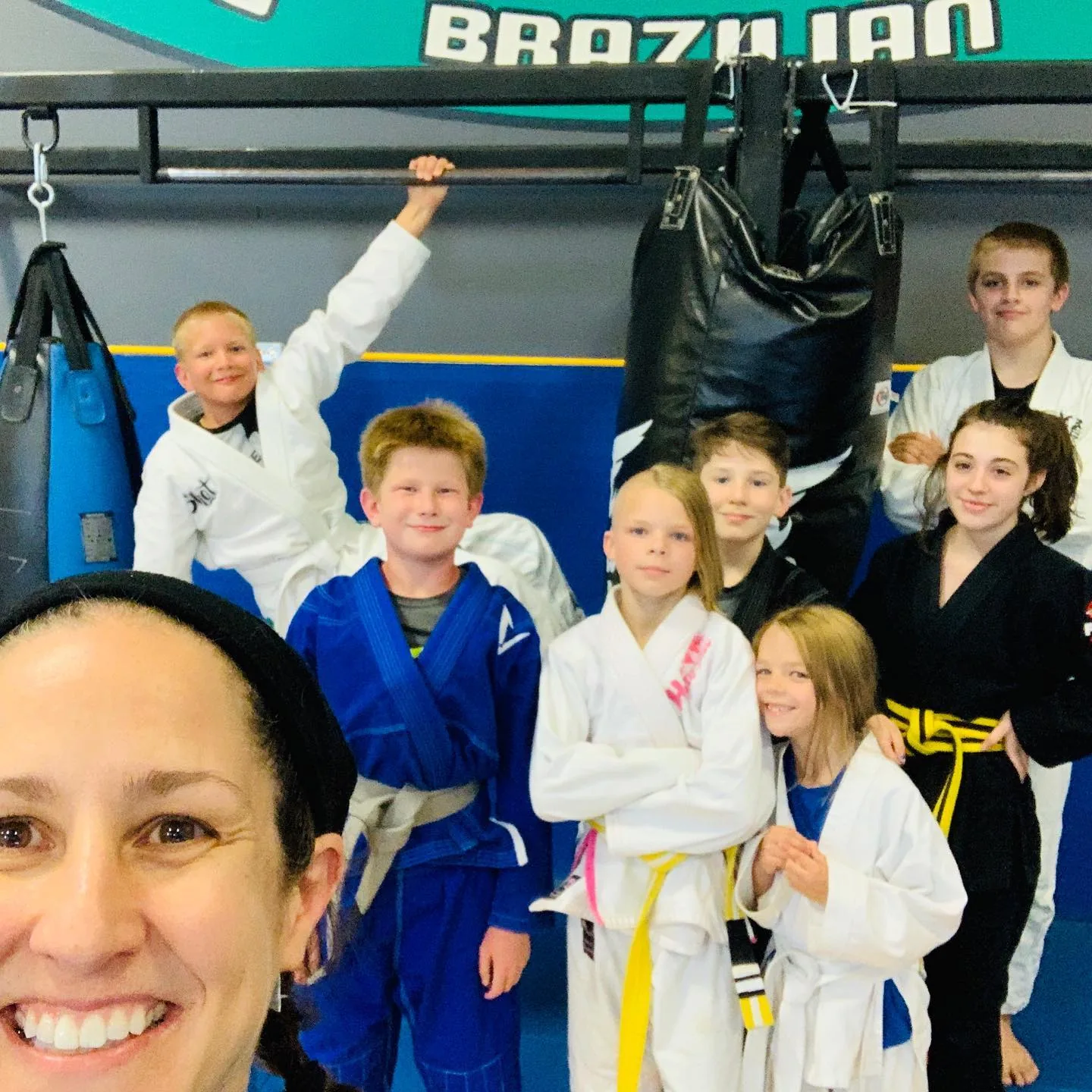 Coach Lora teaching kids BJJ at Zingano